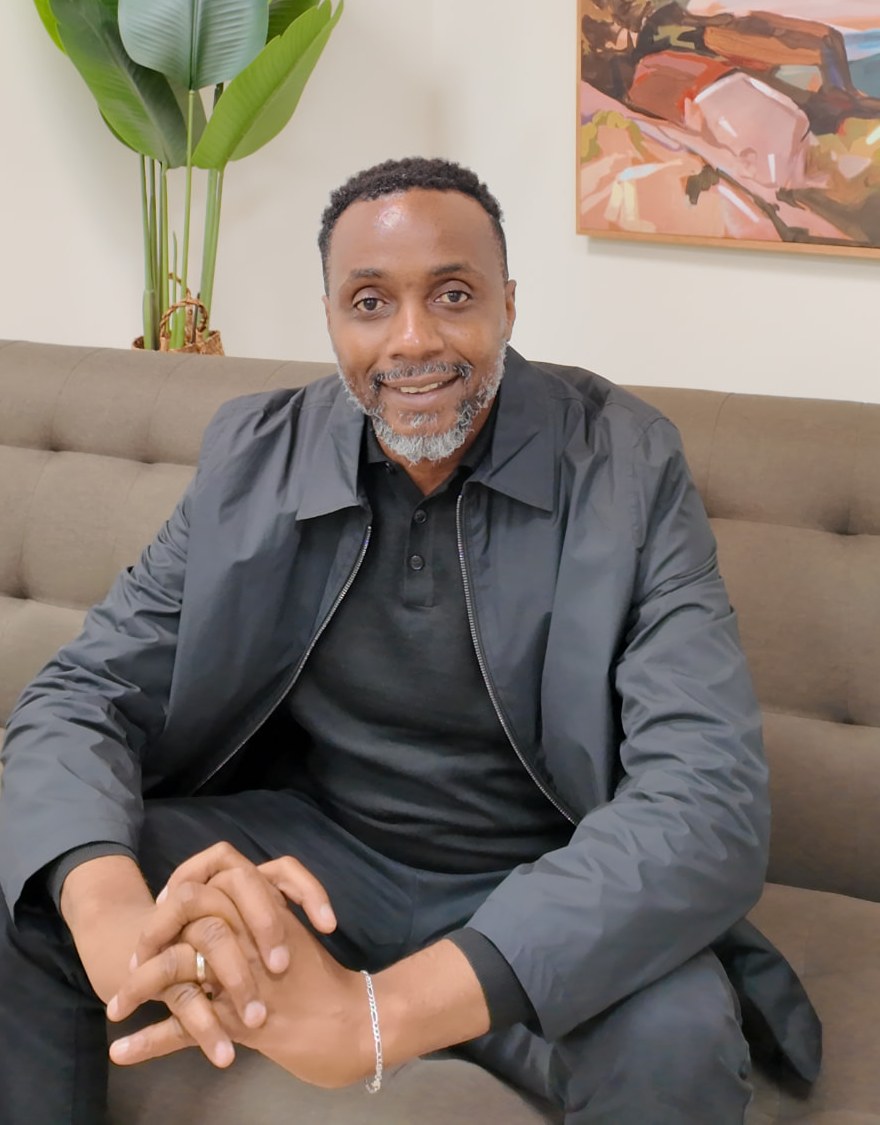 Portrait photograph of Bankole Akinlade, Founder and Managing Director of RockTower Homes, wearing a dark suit against a plain background.